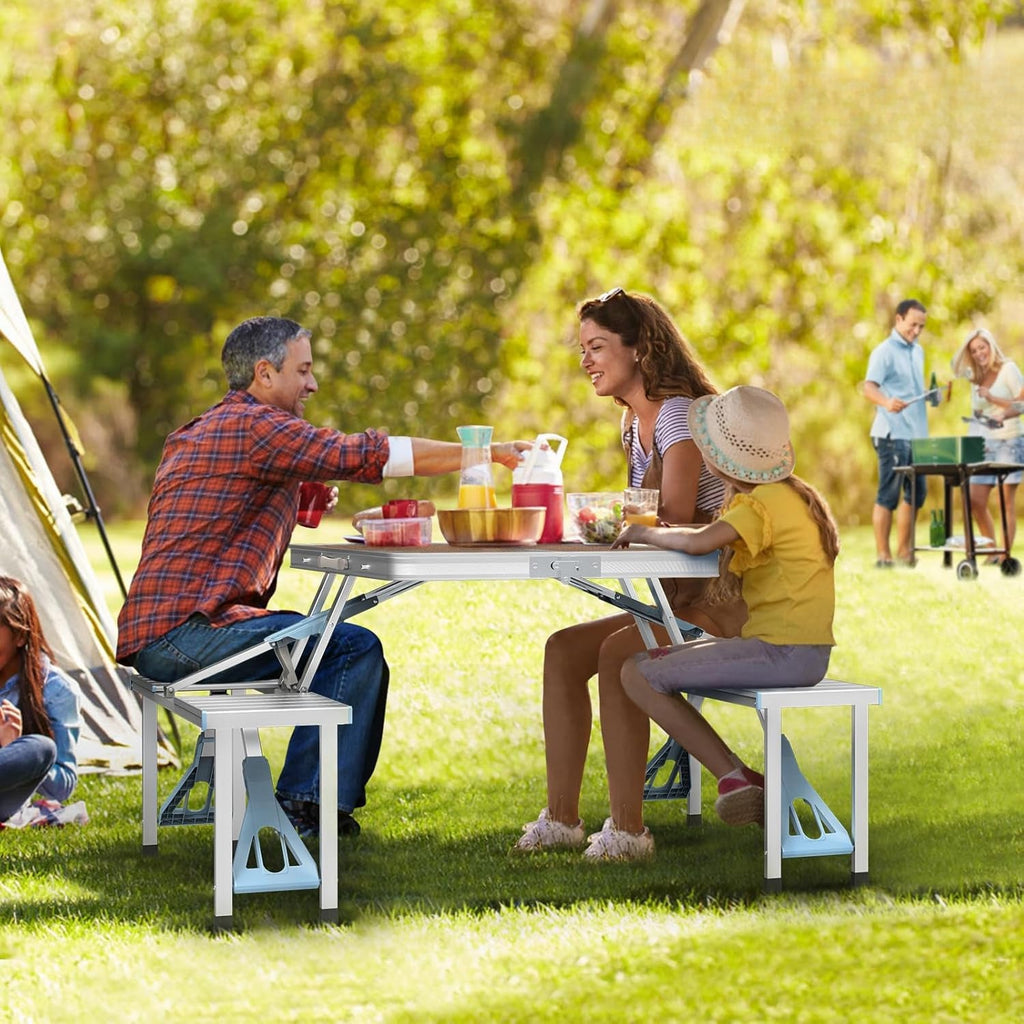 Family having a picnic in a park with tents and people in the background