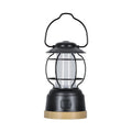 Black lantern with wooden base on a white background