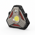 A Fenix tri-angular LED headlight with a black and gray metallic body, featuring a large central yellow LED light, a smaller amber light, and red side reflectors, shown on a plain white background.