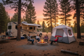 Alps Mountaineering Camp Creek 6-person tent pitched at a campsite next to an RV with family around a fire pit